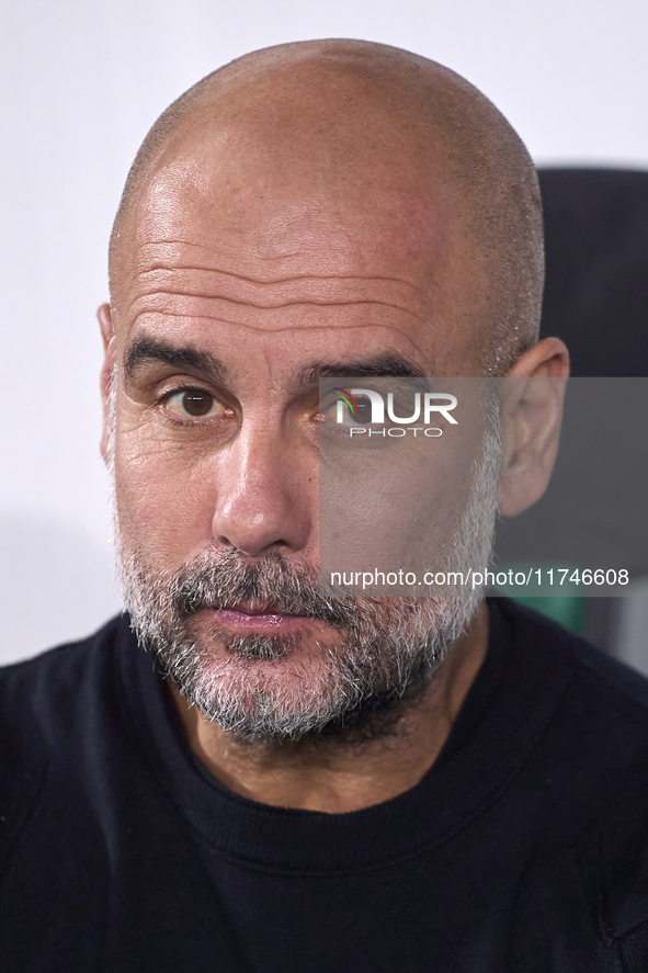 Pep Guardiola, Head Coach of Manchester City, looks on prior to the UEFA Champions League match between Sporting CP and Manchester City at J...