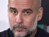 Pep Guardiola, Head Coach of Manchester City, looks on prior to the UEFA Champions League match between Sporting CP and Manchester City at J...