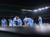 Players of Manchester City high-five each other during the warm-up before the UEFA Champions League match between Sporting CP and Manchester...