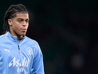 Jahmai Simpson-Pusey of Manchester City warms up before the UEFA Champions League match between Sporting CP and Manchester City at Jose Alva...