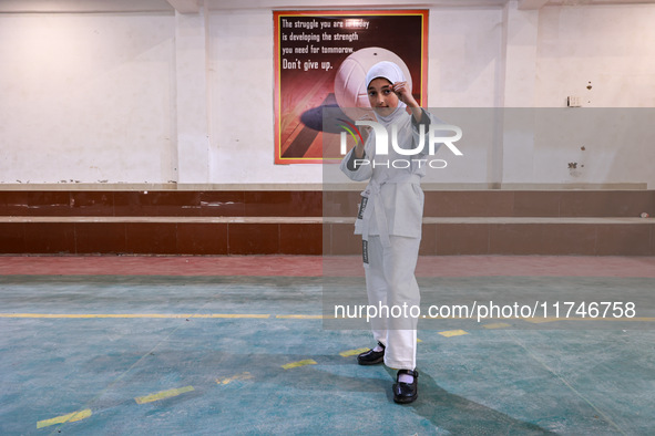 Sumaiya, a 9-year-old girl from Sopore, practices before her karate match at the indoor stadium in Baramulla, Jammu and Kashmir, India, on N...