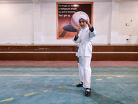 Sumaiya, a 9-year-old girl from Sopore, practices before her karate match at the indoor stadium in Baramulla, Jammu and Kashmir, India, on N...