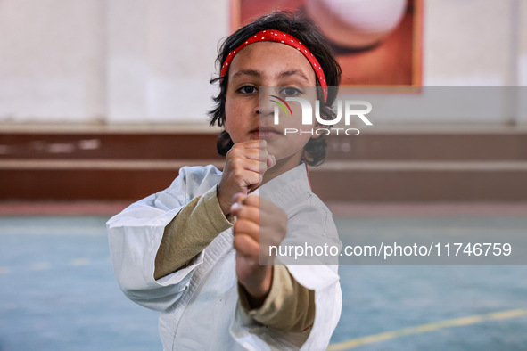 Zara, an 8-year-old girl from Sopore, practices before her karate match at the indoor stadium in Baramulla, Jammu and Kashmir, India, on Nov...