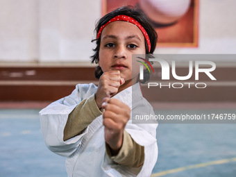 Zara, an 8-year-old girl from Sopore, practices before her karate match at the indoor stadium in Baramulla, Jammu and Kashmir, India, on Nov...