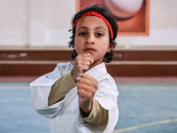 Zara, an 8-year-old girl from Sopore, practices before her karate match at the indoor stadium in Baramulla, Jammu and Kashmir, India, on Nov...