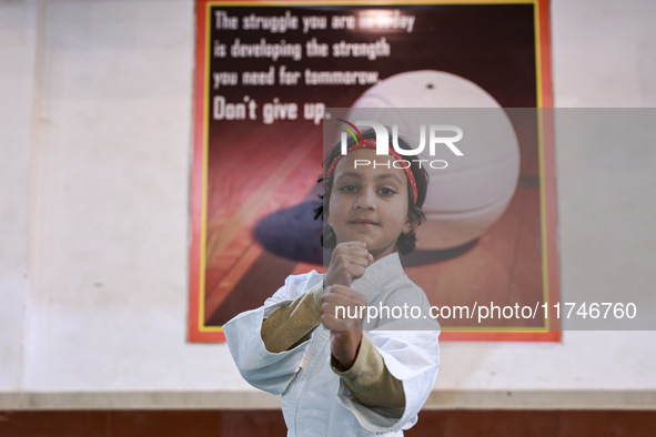 Zara, an 8-year-old girl from Sopore, practices before her karate match at the indoor stadium in Baramulla, Jammu and Kashmir, India, on Nov...