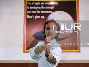 Zara, an 8-year-old girl from Sopore, practices before her karate match at the indoor stadium in Baramulla, Jammu and Kashmir, India, on Nov...