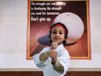 Zara, an 8-year-old girl from Sopore, practices before her karate match at the indoor stadium in Baramulla, Jammu and Kashmir, India, on Nov...