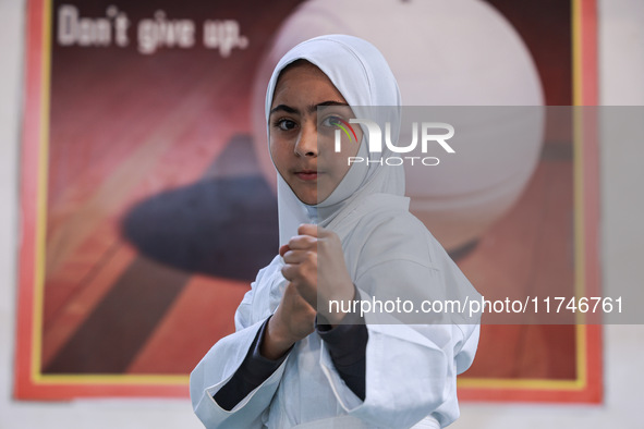 Zainab Fayaz, a 10-year-old girl from Sopore, practices before her karate match at the indoor stadium in Baramulla, Jammu and Kashmir, India...