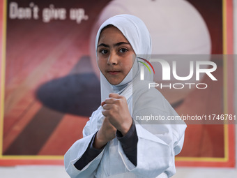 Zainab Fayaz, a 10-year-old girl from Sopore, practices before her karate match at the indoor stadium in Baramulla, Jammu and Kashmir, India...