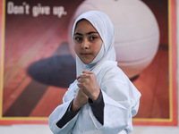 Zainab Fayaz, a 10-year-old girl from Sopore, practices before her karate match at the indoor stadium in Baramulla, Jammu and Kashmir, India...