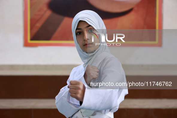 Umiroman, a 10-year-old girl from Sopore, practices before her karate match at the indoor stadium in Baramulla, Jammu and Kashmir, India, on...