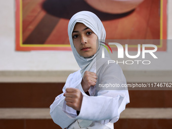 Umiroman, a 10-year-old girl from Sopore, practices before her karate match at the indoor stadium in Baramulla, Jammu and Kashmir, India, on...