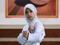 Umiroman, a 10-year-old girl from Sopore, practices before her karate match at the indoor stadium in Baramulla, Jammu and Kashmir, India, on...