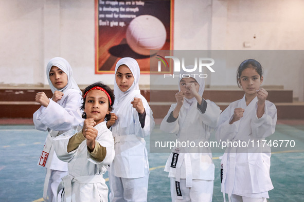 Little girls from Sopore town practice before their karate matches at an indoor stadium in Baramulla, Jammu and Kashmir, India, on November...