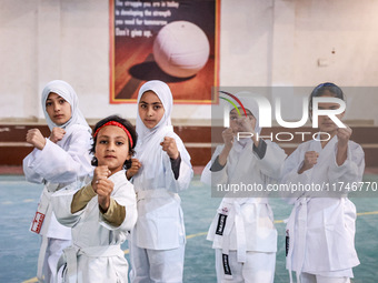 Little girls from Sopore town practice before their karate matches at an indoor stadium in Baramulla, Jammu and Kashmir, India, on November...