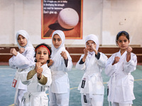 Little girls from Sopore town practice before their karate matches at an indoor stadium in Baramulla, Jammu and Kashmir, India, on November...