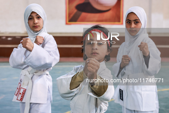 Little girls from Sopore town practice before their karate matches at an indoor stadium in Baramulla, Jammu and Kashmir, India, on November...