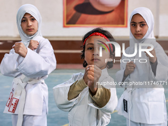 Little girls from Sopore town practice before their karate matches at an indoor stadium in Baramulla, Jammu and Kashmir, India, on November...