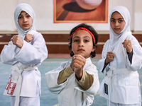 Little girls from Sopore town practice before their karate matches at an indoor stadium in Baramulla, Jammu and Kashmir, India, on November...