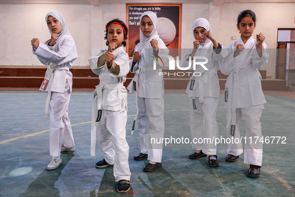 Little girls from Sopore town practice before their karate matches at an indoor stadium in Baramulla, Jammu and Kashmir, India, on November...