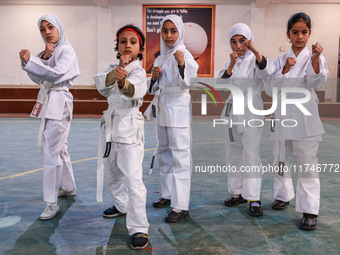 Little girls from Sopore town practice before their karate matches at an indoor stadium in Baramulla, Jammu and Kashmir, India, on November...