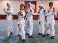 Little girls from Sopore town practice before their karate matches at an indoor stadium in Baramulla, Jammu and Kashmir, India, on November...