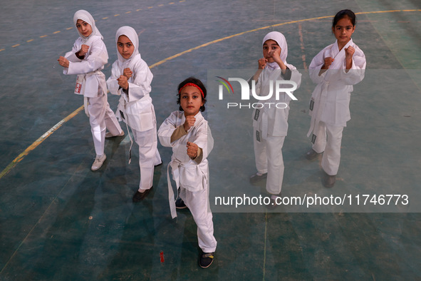 Little girls from Sopore town practice before their karate matches at an indoor stadium in Baramulla, Jammu and Kashmir, India, on November...