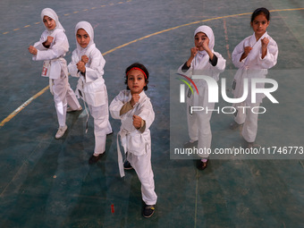 Little girls from Sopore town practice before their karate matches at an indoor stadium in Baramulla, Jammu and Kashmir, India, on November...