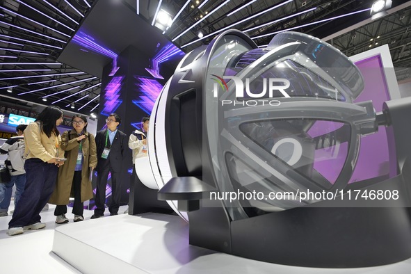 Visitors learn about the world's first radiation surgery robot model with a self-shielding function at the 7th CIIE in Shanghai, China, on N...