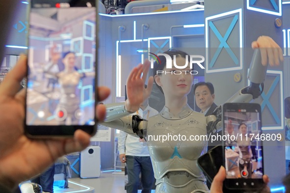 Visitors watch a humanoid robot ''Xiaohui'' perform a song and dance at the 7th CIIE in Shanghai, China, on November 6, 2024. 