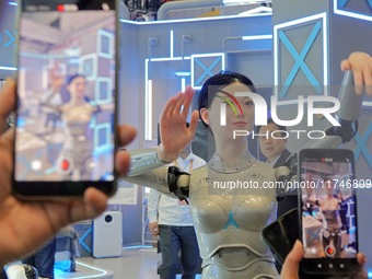 Visitors watch a humanoid robot ''Xiaohui'' perform a song and dance at the 7th CIIE in Shanghai, China, on November 6, 2024. (