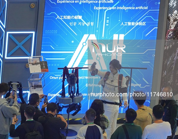 Visitors experience exoskeleton robot equipment at the 7th CIIE in Shanghai, China, on November 6, 2024. 