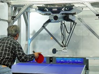 Visitors play ball with the Omron FORPHEUS table tennis coaching robot at the 7th CIIE in Shanghai, China, on November 6, 2024. (