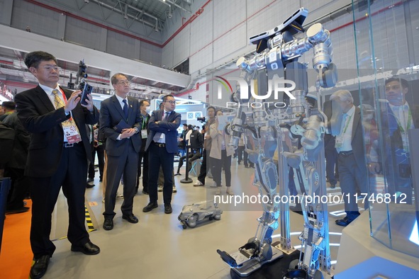 Visitors look at the Qiyuan ETH 01 humanoid composite exoskeleton robot at the 7th CIIE in Shanghai, China, on November 6, 2024. 