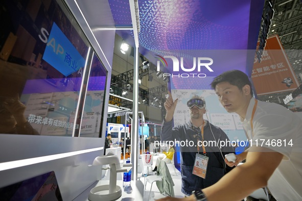 Visitors experience an AI+ intelligent decision-making system at the 7th CIIE in Shanghai, China, on November 6, 2024. 