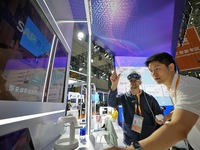 Visitors experience an AI+ intelligent decision-making system at the 7th CIIE in Shanghai, China, on November 6, 2024. (