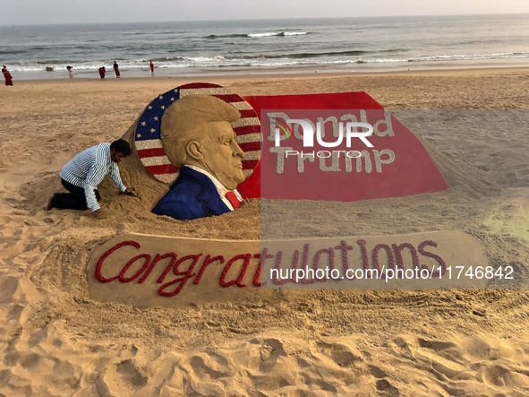 A sand sculpture of newly elected U.S. President Donald Trump is seen on the eastern coast beach of the Bay of Bengal at Puri, approximately...