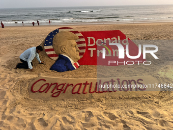 A sand sculpture of newly elected U.S. President Donald Trump is seen on the eastern coast beach of the Bay of Bengal at Puri, approximately...