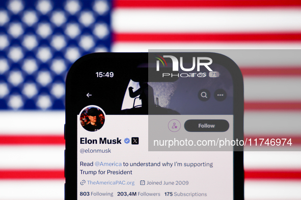 American flag displayed on a laptop screen and Elon Musk account on X displayed on a phone screen are seen in this illustration photo taken...