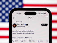 American flag displayed on a laptop screen and Elon Musk account on X displayed on a phone screen are seen in this illustration photo taken...