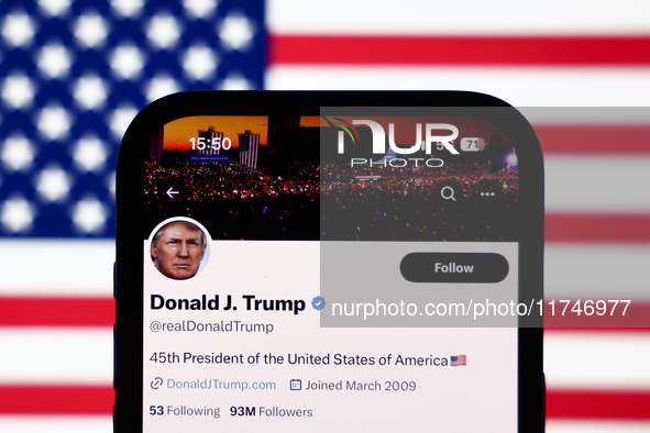 American flag displayed on a laptop screen and Donald Trump account on X displayed on a phone screen are seen in this illustration photo tak...