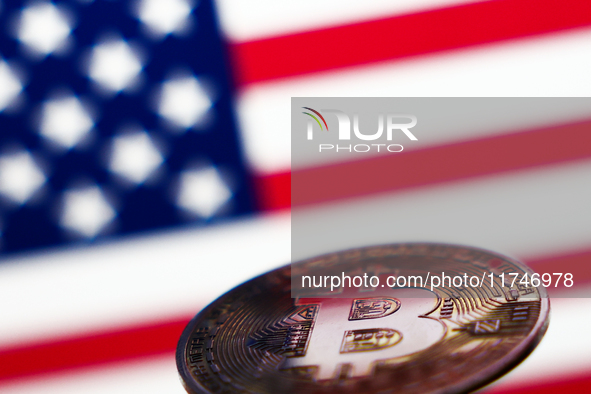 American flag displayed on a laptop screen and representation of Bitcoin cryptocurrency are seen in this illustration photo taken in Krakow,...