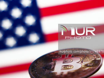 American flag displayed on a laptop screen and representation of Bitcoin cryptocurrency are seen in this illustration photo taken in Krakow,...