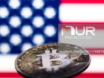 American flag displayed on a laptop screen and representation of Bitcoin cryptocurrency are seen in this illustration photo taken in Krakow,...