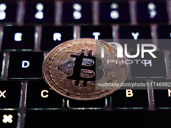 A laptop keyboard and representation of Bitcoin cryptocurrency are seen in this illustration photo taken in Krakow, Poland on November 6, 20...