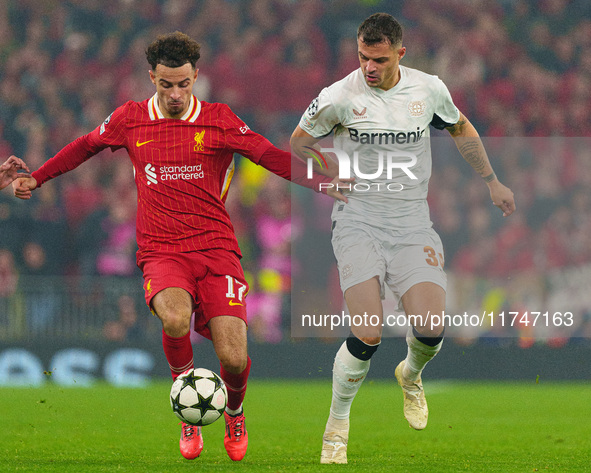 Liverpool's Curtis Jones battles with Granit Xhaka of Bayer Leverkusen during the UEFA Champions League 2024/25 League Phase MD4 match betwe...