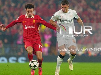 Liverpool's Curtis Jones battles with Granit Xhaka of Bayer Leverkusen during the UEFA Champions League 2024/25 League Phase MD4 match betwe...