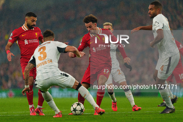 Liverpool's Curtis Jones looks for a way through Piero Hincapie and Jonathan Tah of Bayer Leverkusen during the UEFA Champions League 2024/2...