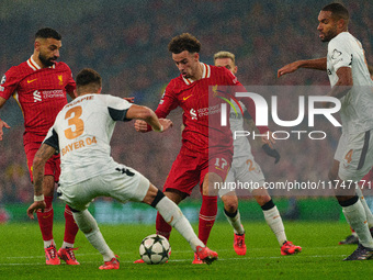 Liverpool's Curtis Jones looks for a way through Piero Hincapie and Jonathan Tah of Bayer Leverkusen during the UEFA Champions League 2024/2...